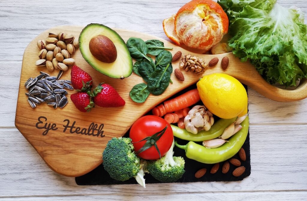 A bunch of fruits and vegetables on a cutting board.