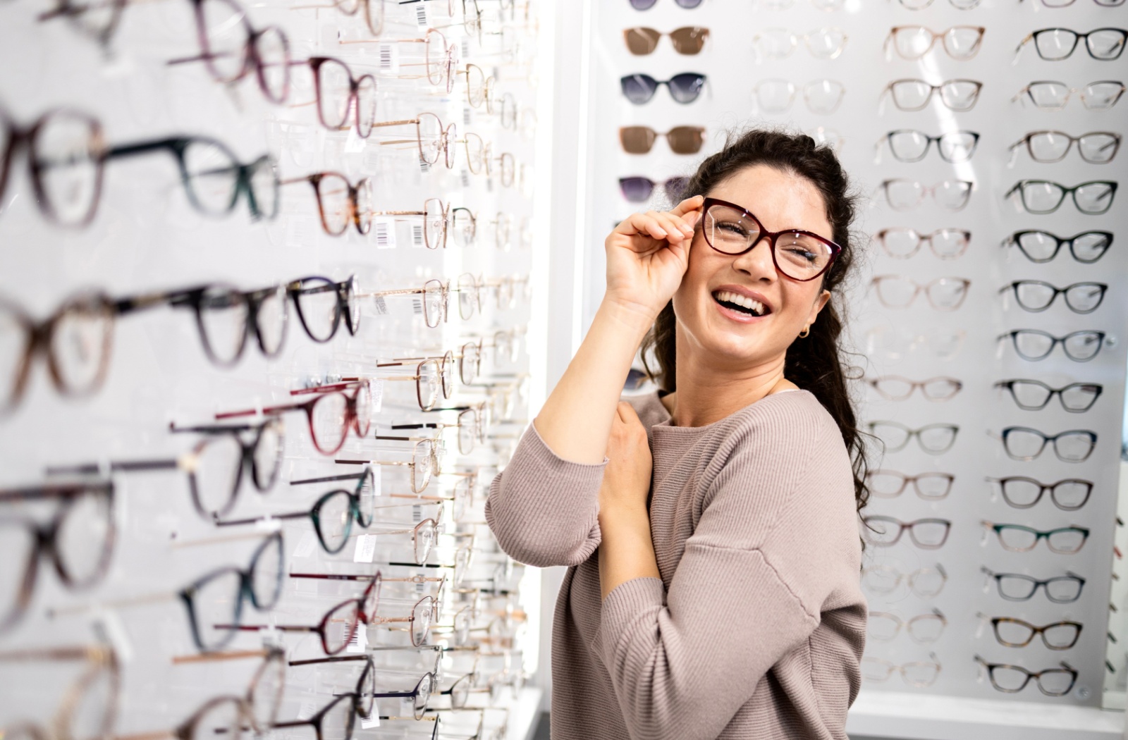 A person trying on eyeglasses at an optometry office.